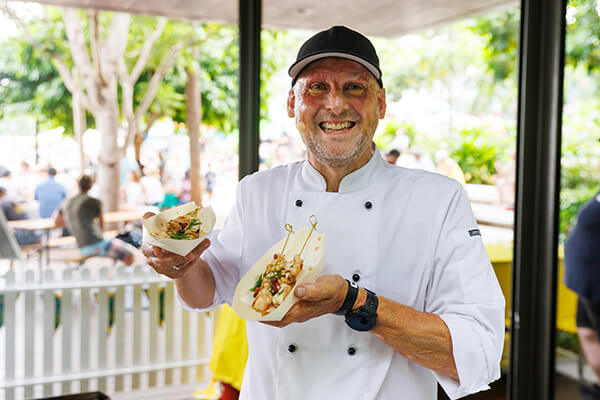 Queensland chef Matt Golinski holding prawn skewers.