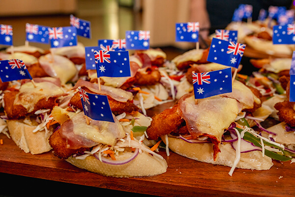 Chicken parmigiana sandwiches with mini Australian flags skewered on top.