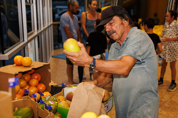  A man holding a mango.